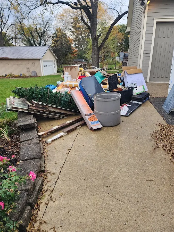 Dumpster being loaded with debris for 3 Yard Dumpster Rental in Denton